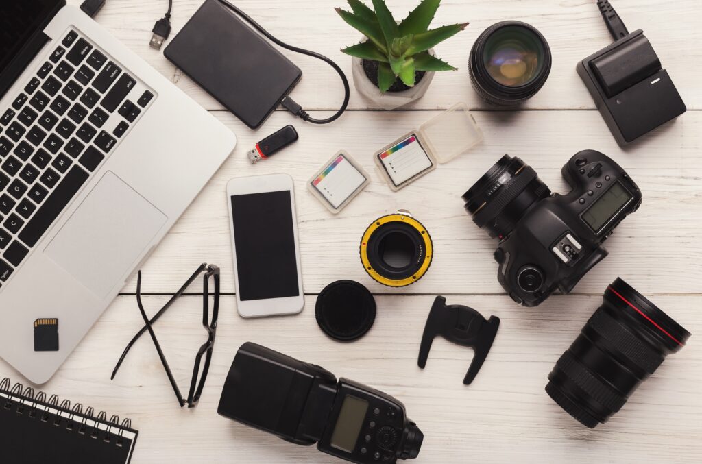 Camera equipment and computer layer out on desk