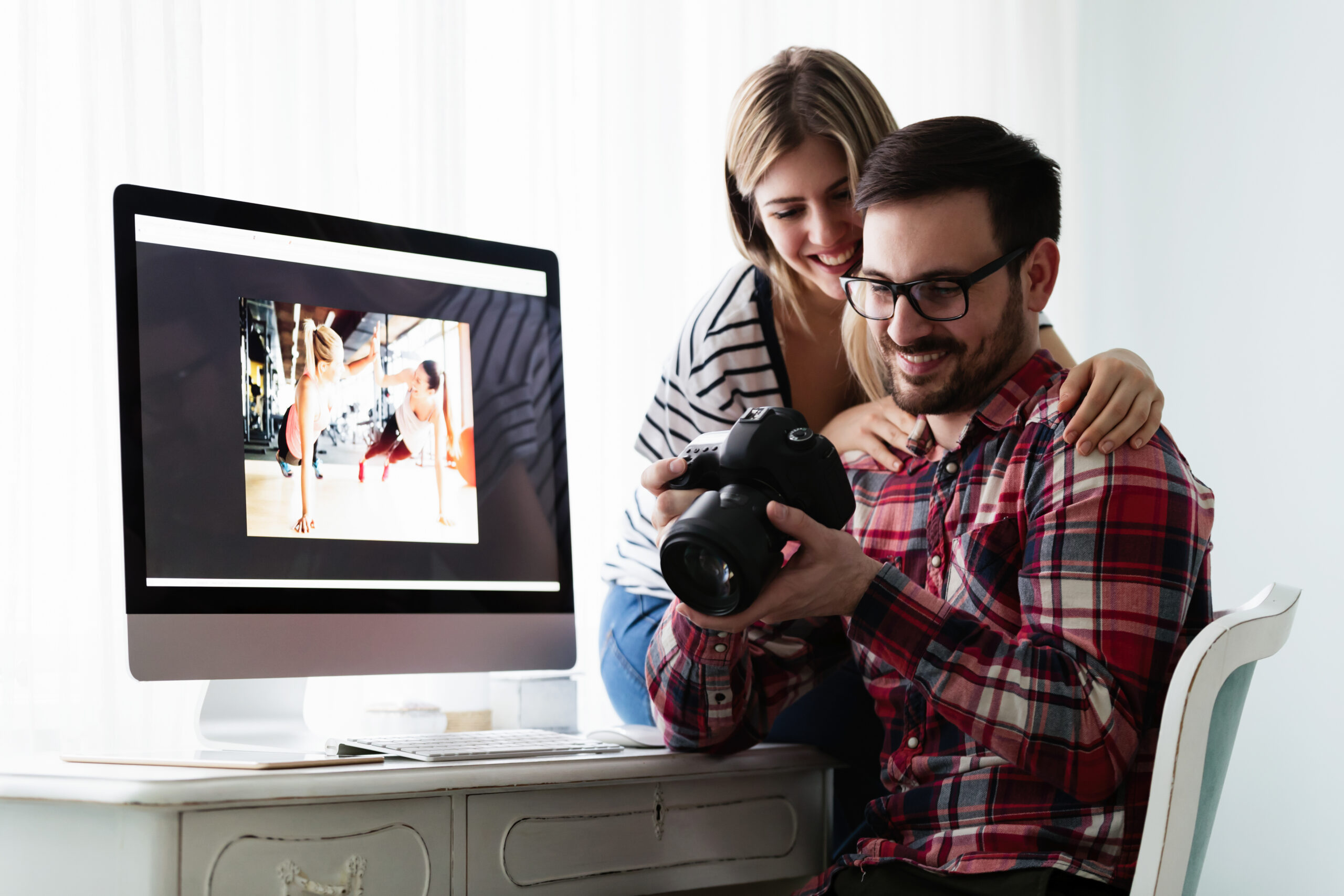 Young couple looking at photos while editing